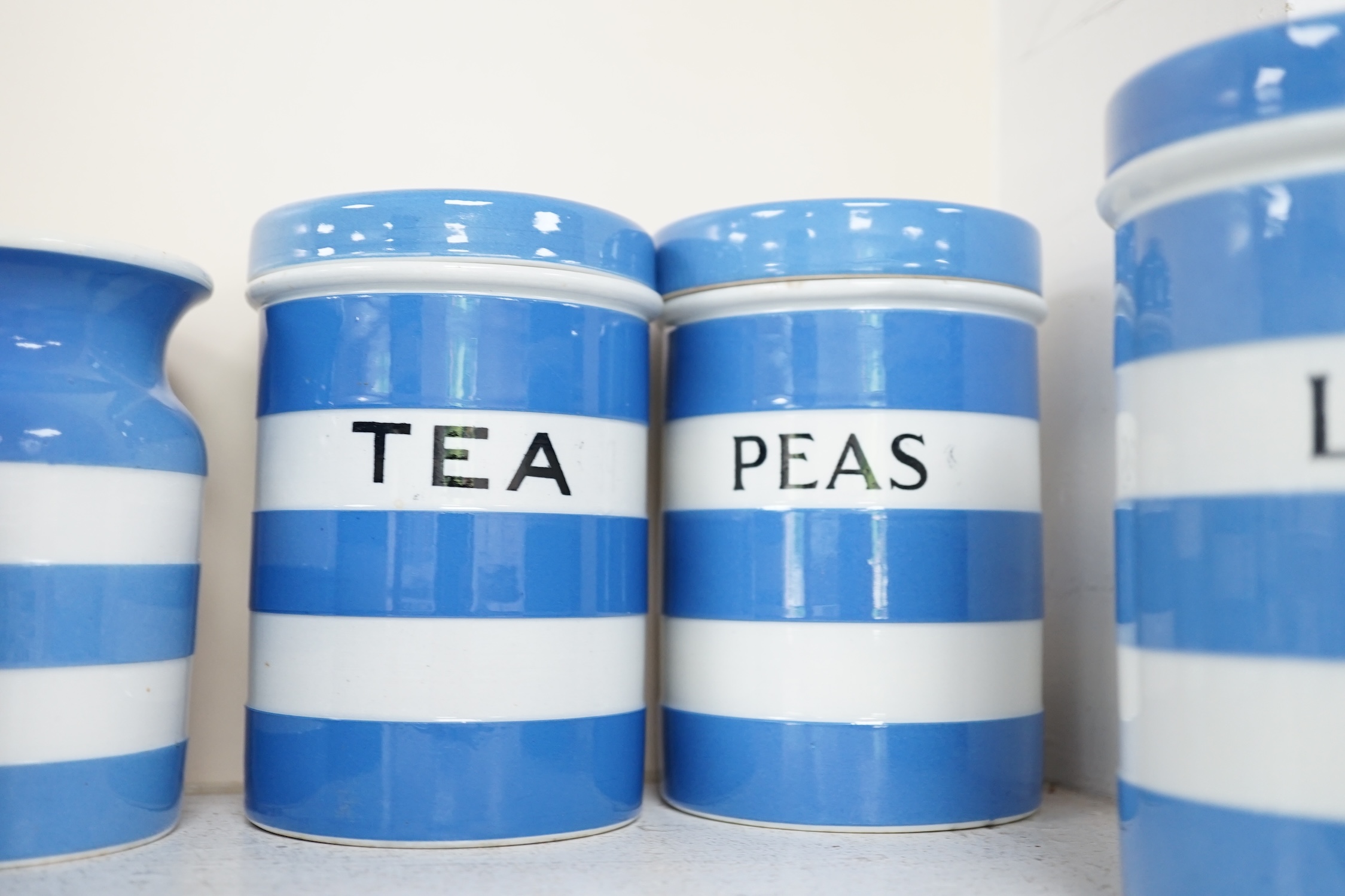 T.G.Green Cornish Kitchenware, fifteen lidded storage jars, to include Moist Sugar, Spaghetti, Semolina, Patna Rice, Brown Rice, Butter and Lard, largest 14cm high, Black Shield marks. Condition - poor, fair and good
